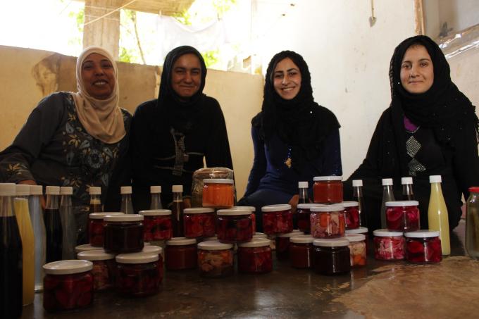 Reyaq (second from right), 20, with her colleagues and their homemade food items. Photo Save the Children